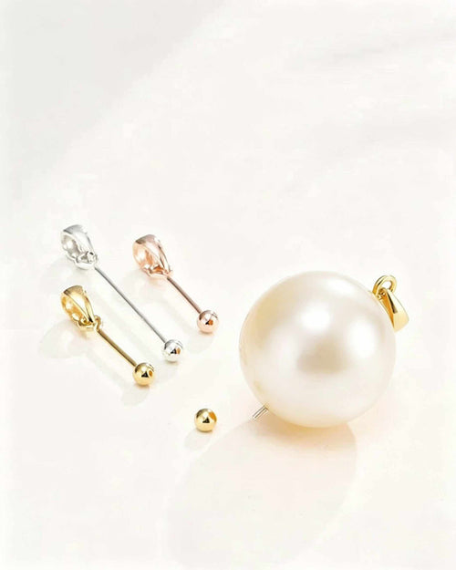 Set of pearl earrings with gold and silver clasps on a light background