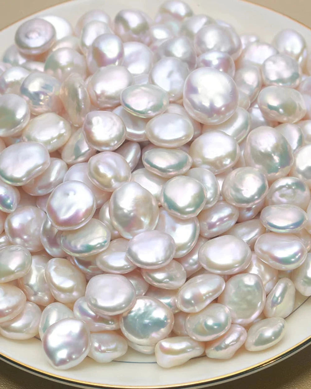 Close-up of various pearls on a white plate
