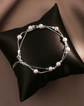 Pearl bracelet on a dark fabric background