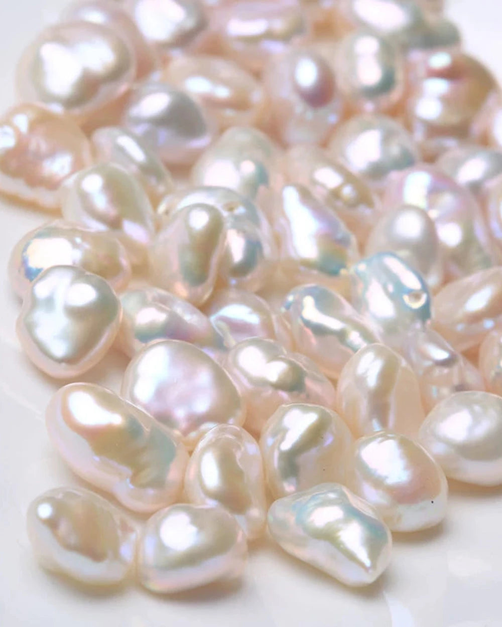 Close-up of irregularly shaped pearls on a white background