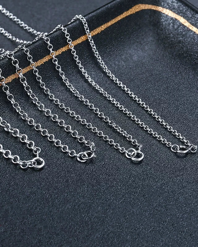 Silver chains on a dark textured surface
