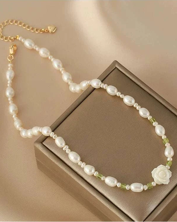 Pearl necklace with a flower pendant on a brown box