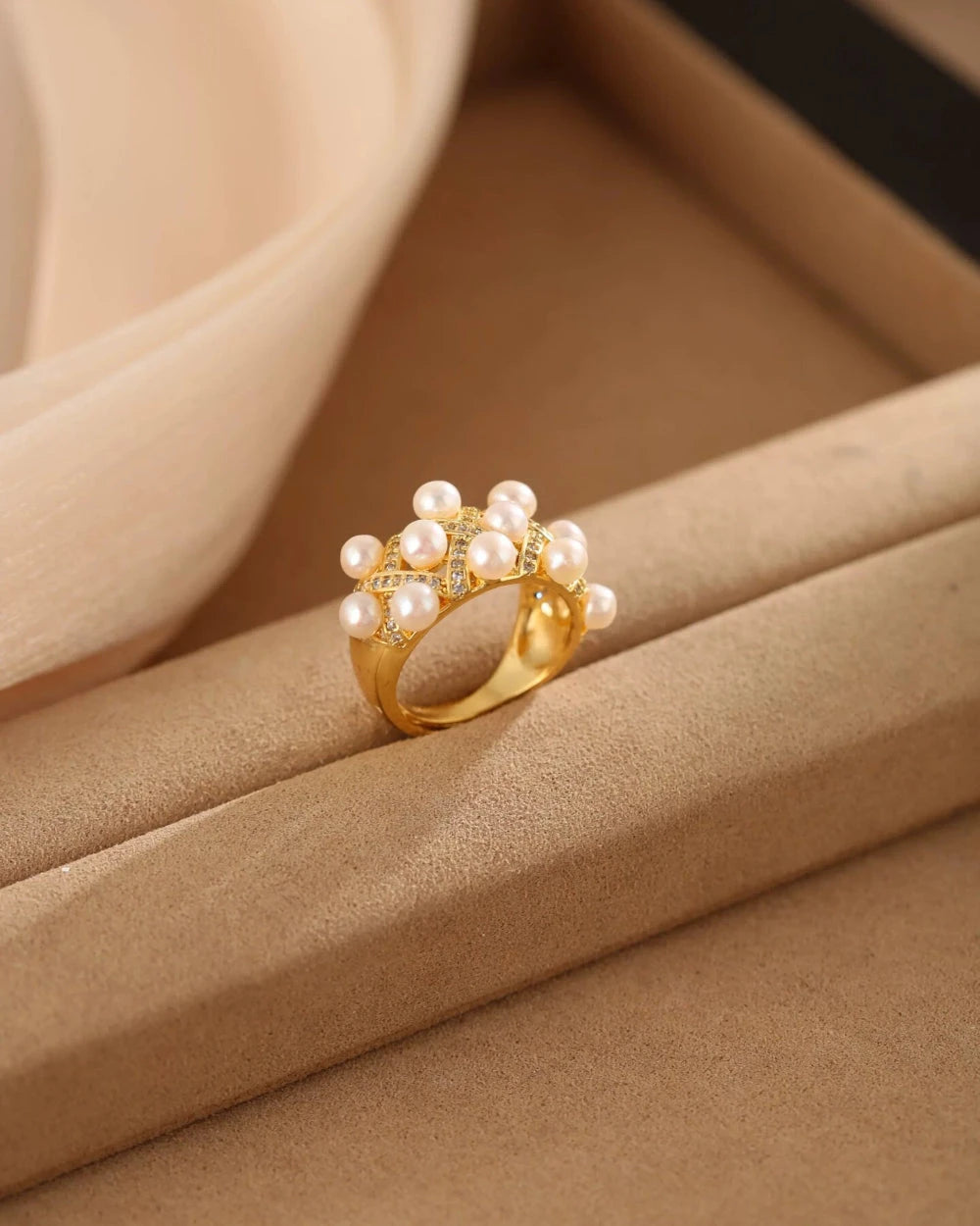 Gold ring with pearls on a brown surface