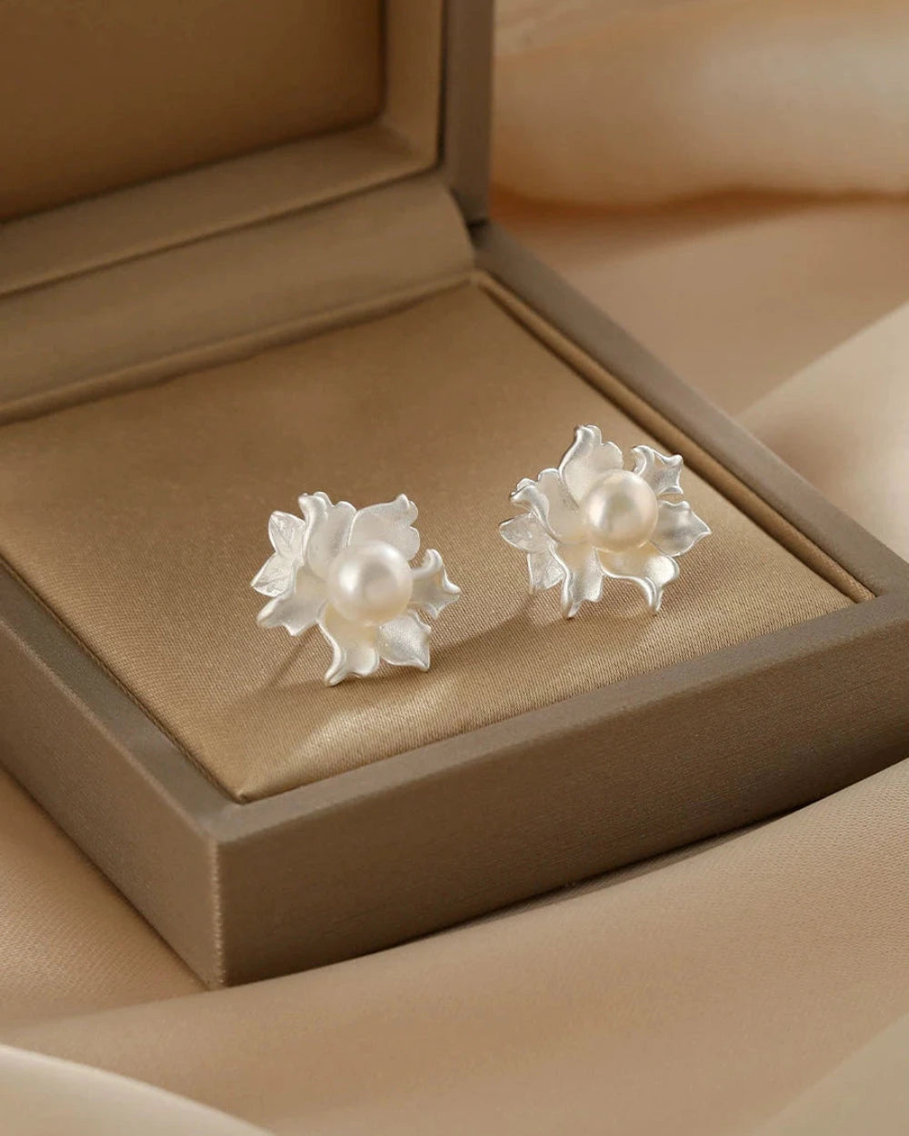 Pearl earrings in a brown jewelry box