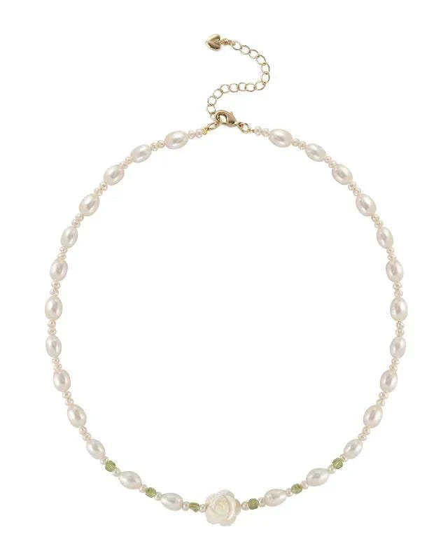 Pearl necklace with a rose charm on a white background