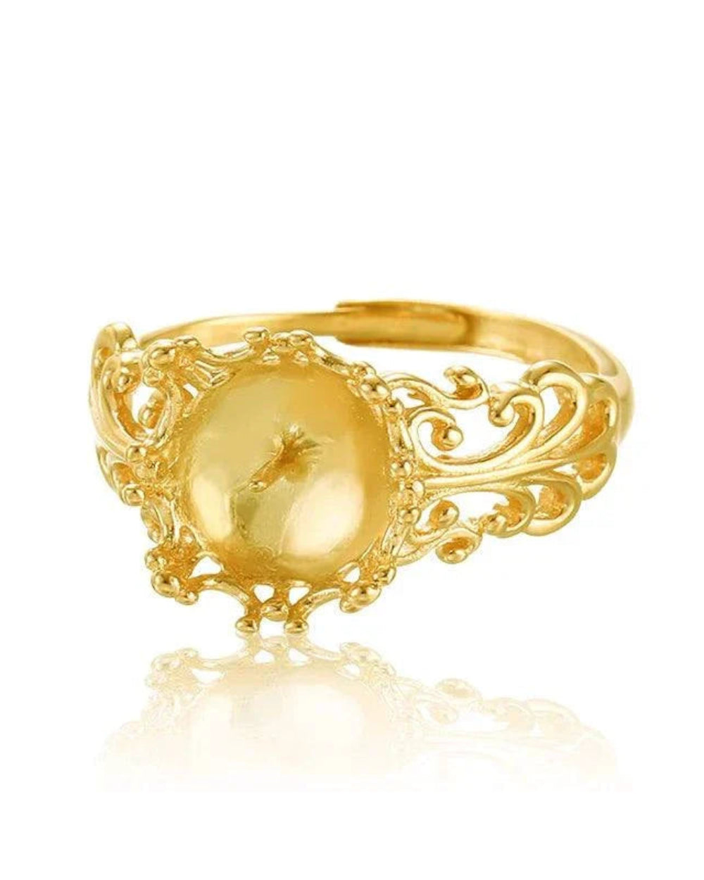 Gold ring with intricate design on a white background