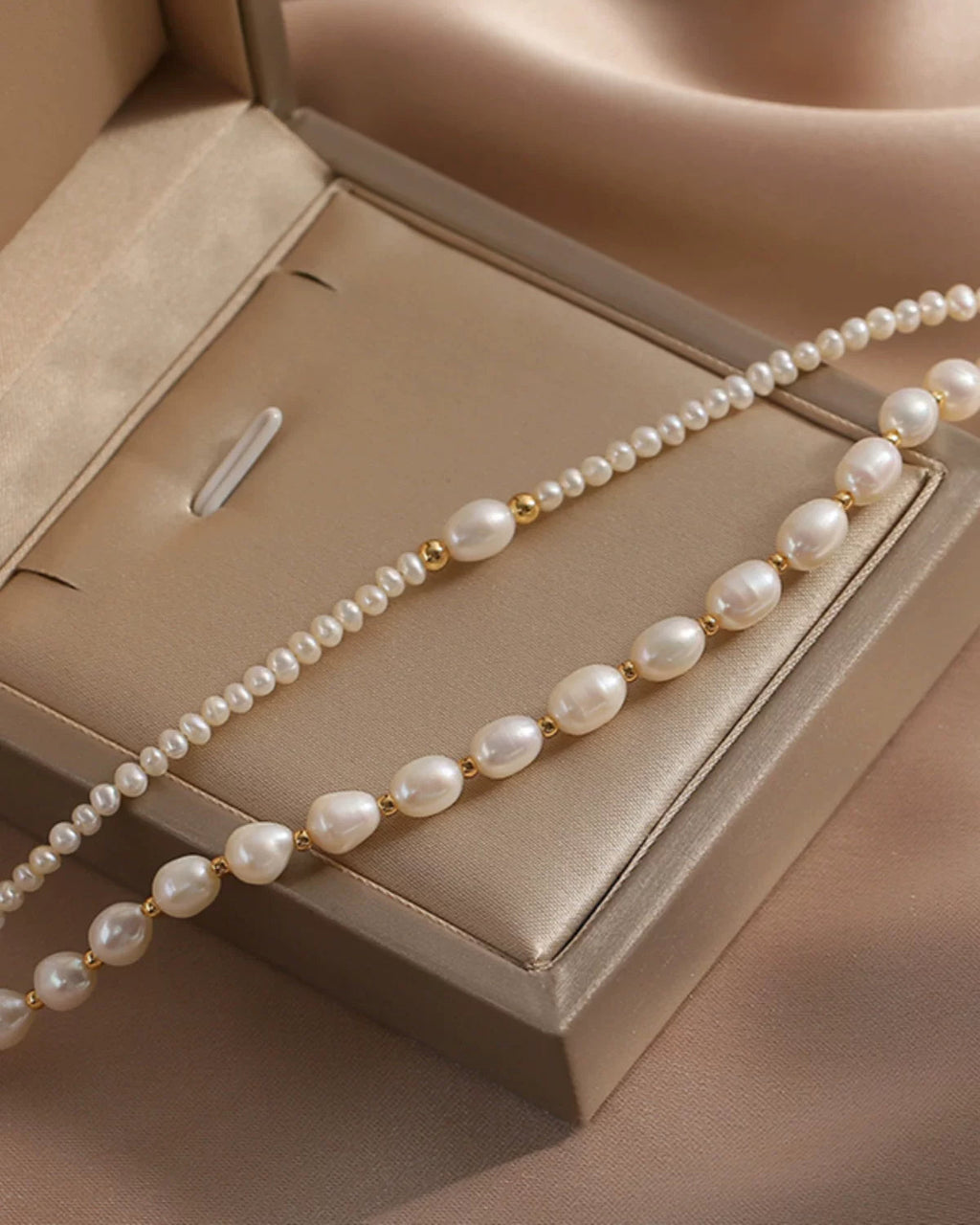 Pearl necklace on a beige jewelry box