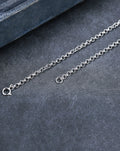 Silver bracelet on a dark gray surface