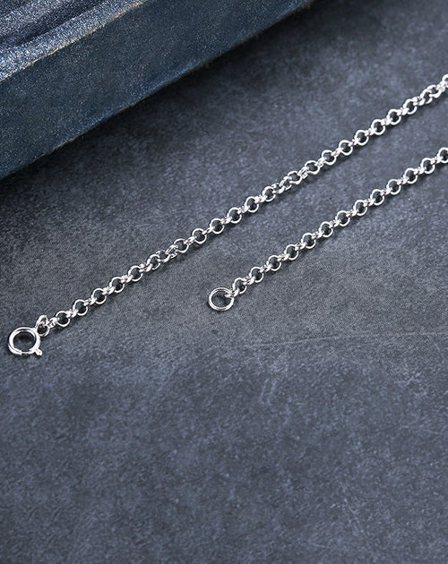 Silver bracelet on a dark gray surface