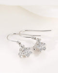 Silver earrings with floral designs on a white background